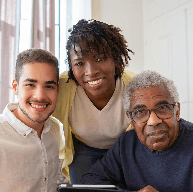 Circular group photo featuring three adults smiling broadly. One has long dark hair, another has short dark hair, and the third is older, with grey hair. Circular group photo featuring three adults smiling broadly. One has long dark hair, another has short dark hair, and the third is older, with grey hair.