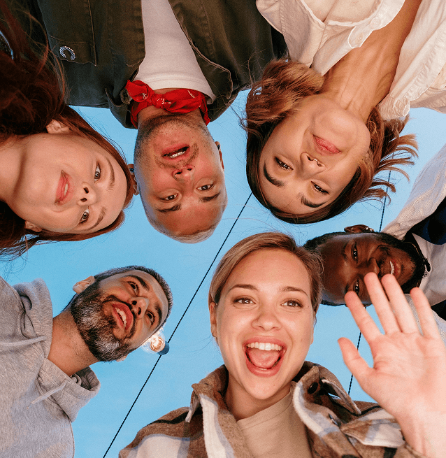 Circular group photo showcasing a diverse mix of smiling individuals of various ages and ethnicities, looking at the camera. Circular group photo showcasing a diverse mix of smiling individuals of various ages and ethnicities, looking at the camera.